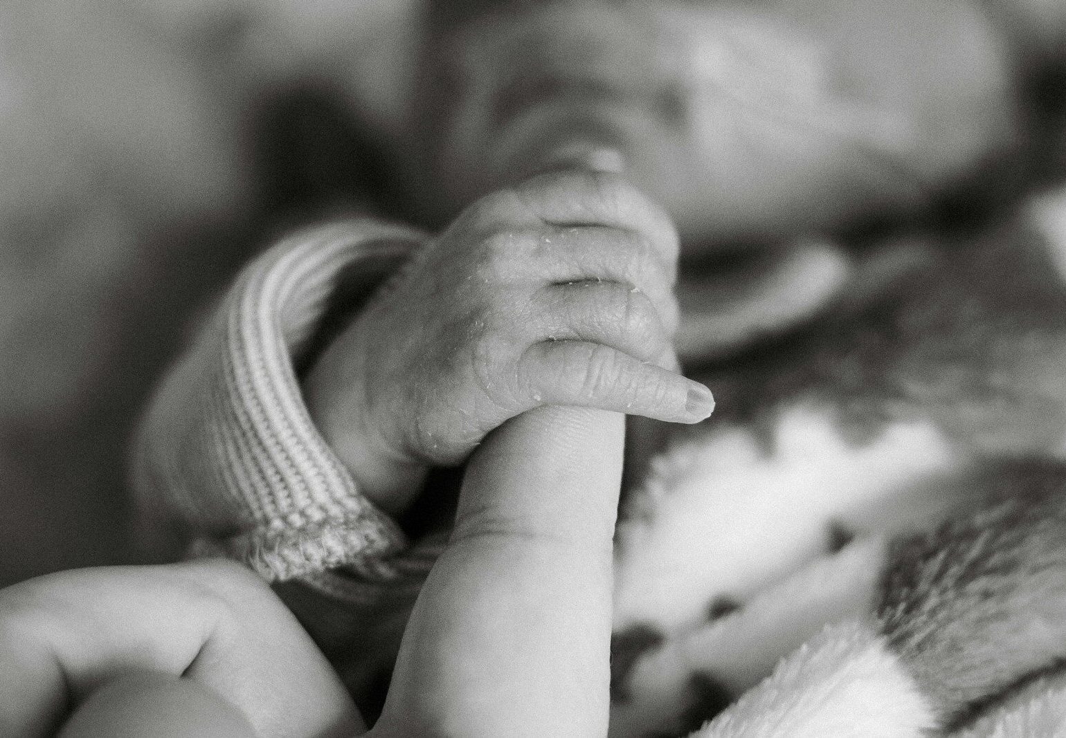 a close up of a person holding a baby
